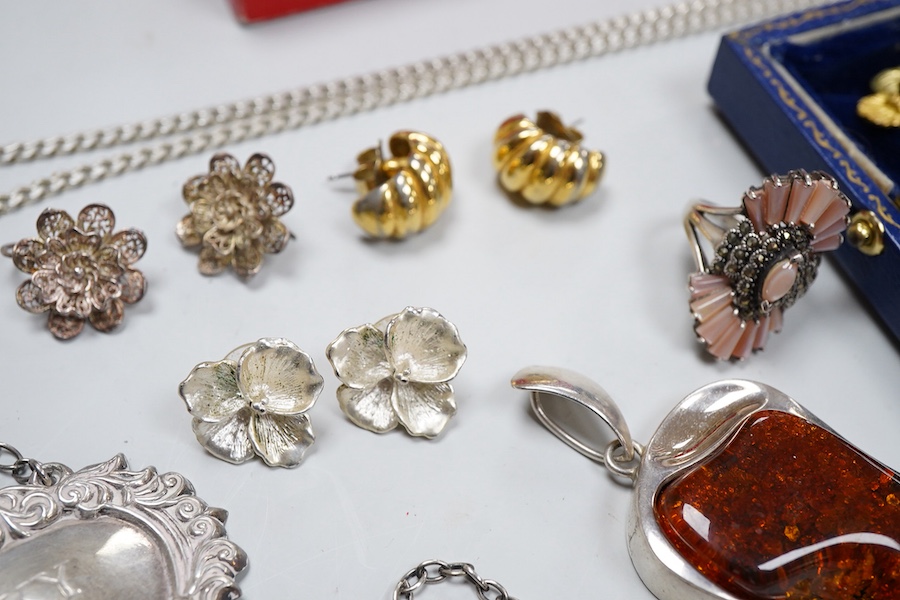 A collection of jewels, comprising: two amber pendants and an amber ring, each mounted in silver; a pair of gilt metal and enamel earrings of floral design; a pair of gilt metal earrings; a silver and cultured brooch; a